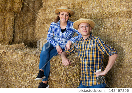 Portrait of a positive farmers resting near haystacks Portrait of a positive farmers resting near haystacks 142467296