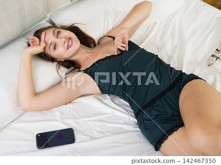 woman in home clothes woke up in a bed woman in home clothes woke up in a bed 142467350