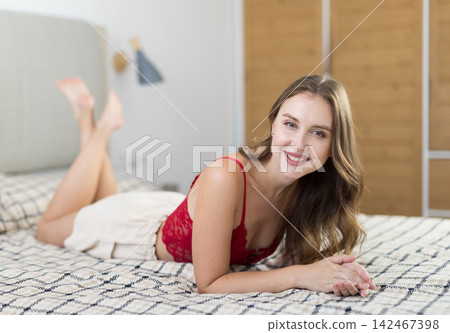 Young woman alone in bedroom, posing and enjoy home time 142467398