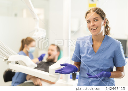 Female dentist invites you to visit dental clinic Female dentist invites you to visit dental clinic 142467415