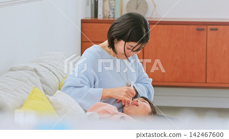 Image of a mother brushing her teeth Image of a mother brushing her teeth 142467600