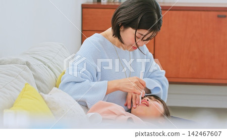 Image of a mother brushing her teeth Image of a mother brushing her teeth 142467607
