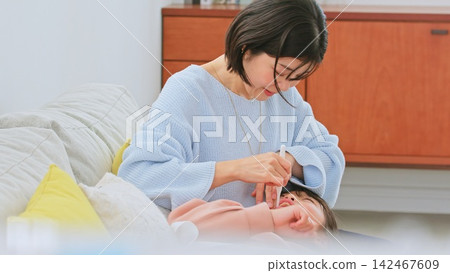 Image of a mother brushing her teeth Image of a mother brushing her teeth 142467609