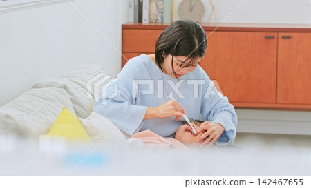 Image of a mother brushing her teeth Image of a mother brushing her teeth 142467655