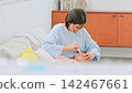 Image of a mother brushing her teeth 142467661
