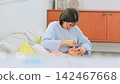 Image of a mother brushing her teeth 142467668