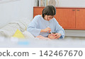 Image of a mother brushing her teeth 142467670