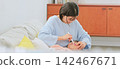 Image of a mother brushing her teeth 142467671