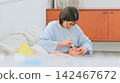 Image of a mother brushing her teeth 142467672