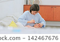 Image of a mother brushing her teeth 142467676