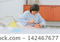 Image of a mother brushing her teeth 142467677