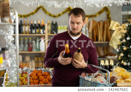 Man choosing wine in supermarket 142467681