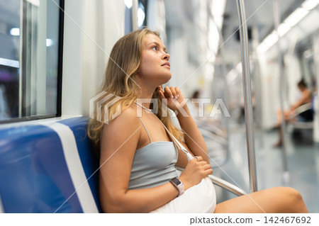 Young girl sitting in wagon travelling by subway Young girl sitting in wagon travelling by subway 142467692