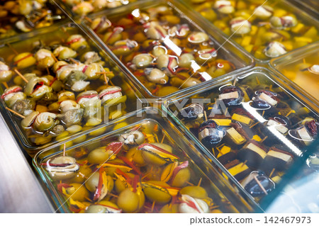 Variety of stuffed marinated olives in glass containers for sale Variety of stuffed marinated olives in glass containers for sale 142467973