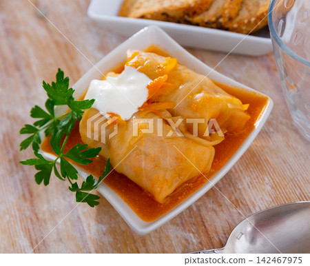 Portion of russian cabbage rolls served with smetana Portion of russian cabbage rolls served with smetana 142467975