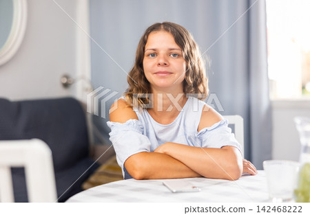 Smiling girl at home interior, posing on camera Smiling girl at home interior, posing on camera 142468222