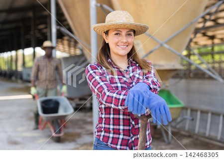 Latino american female farmer standing at the cow farm 142468305