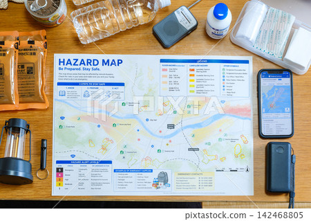 Disaster preparedness: Hazard maps, smartphone typhoon path forecasts, and a display of disaster relief supplies. Disaster preparedness: Hazard maps, smartphone typhoon path forecasts, and a display of disaster relief supplies. 142468805