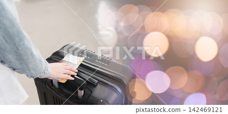Close up hands woman tourist going to flight with suitcase holding Thailand passport and airline ticket on baggage Close up hands woman tourist going to flight with suitcase holding Thailand passport and airline ticket on baggage 142469121
