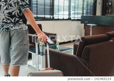 Close up hands the man going to flight with suitcase holding Thailand passport and airline ticket on baggage luggage Close up hands the man going to flight with suitcase holding Thailand passport and airline ticket on baggage luggage 142469124