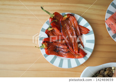 Grilled red peppers on a plate Grilled red peppers on a plate 142469659
