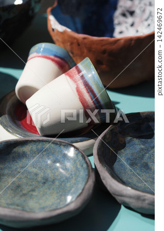Colorful pottery displayed at an artisan market 142469672