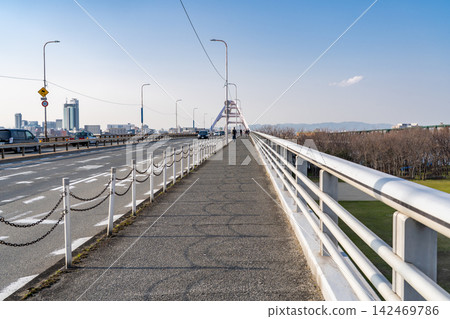 A view from Nagara Bridge over the Yodo River in Osaka (with the cityscape of Shin-Osaka and the mountains of Minoh in the distance). A view from Nagara Bridge over the Yodo River in Osaka (with the cityscape of Shin-Osaka and the mountains of Minoh in the distance). 142469786