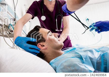 Doctors give resuscitation to a male patient in the emergency room. Cardiac massage Doctors give resuscitation to a male patient in the emergency room. Cardiac massage 142469964