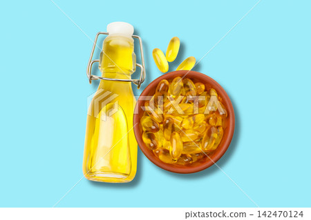 Omega 3. Bottles of omega fish oil capsules placed next to a bowl of softgel capsules. Omega 3. Bottles of omega fish oil capsules placed next to a bowl of softgel capsules. 142470124