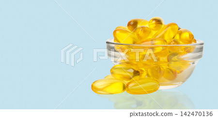 Omega 3. Fish oil capsules are neatly arranged in a glass bowl. Omega 3. Fish oil capsules are neatly arranged in a glass bowl. 142470136