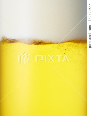 Draft beer poured into a glass, close-up Draft beer poured into a glass, close-up 142470627
