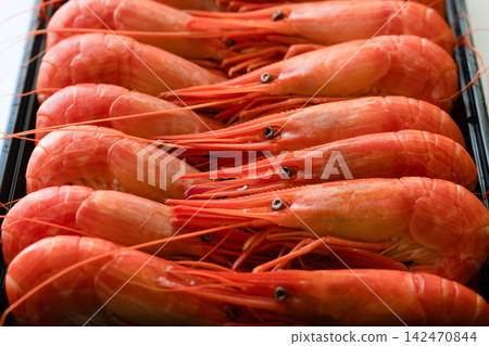 A photo of a tray full of fresh red shrimp. A photo of a tray full of fresh red shrimp. 142470844