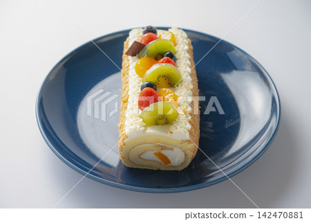 Fruit roll cake served in a navy blue dish Fruit roll cake served in a navy blue dish 142470881