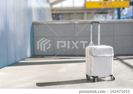 A white suitcase placed on the train platform A white suitcase placed on the train platform 142471055