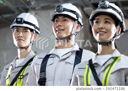 Men and women working at a construction site Men and women working at a construction site 142471186