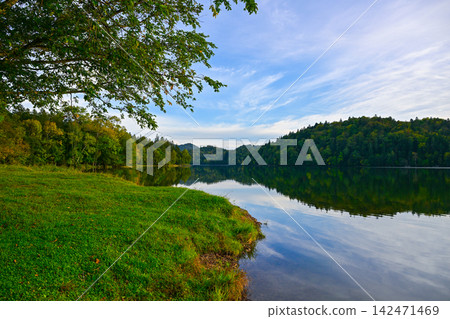 Lake Chimikeppu, where the blue sky and primeval forest are reflected on the surface of the water. Lake Chimikeppu, where the blue sky and primeval forest are reflected on the surface of the water. 142471469