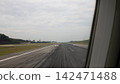 View along an airport runway from an aircraft window during take-off 142471488