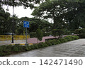 Empty city park walkway with an underpass direction sign 142471490