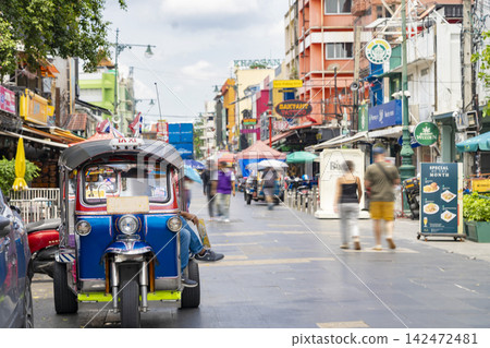The bustling Khao San Road in Bangkok, Thailand, and a parked tuk-tuk. The bustling Khao San Road in Bangkok, Thailand, and a parked tuk-tuk. 142472481