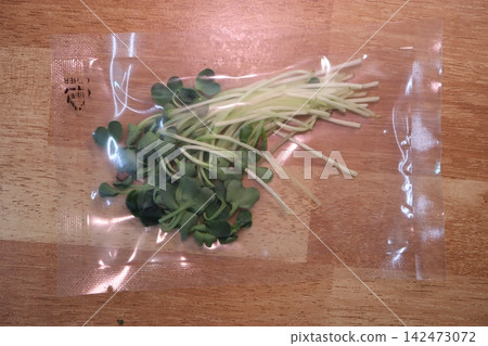Fresh Sprouts in Plastic Bag on Wooden Surface Fresh Sprouts in Plastic Bag on Wooden Surface 142473072