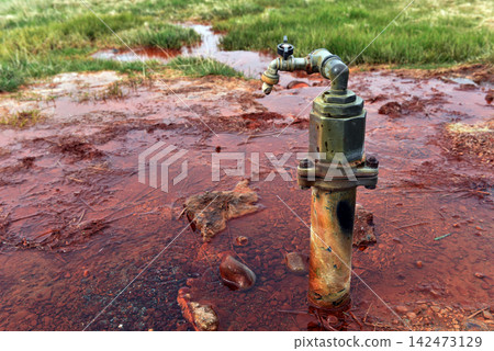 Rusty faucet tapping an iron rich mineral water spring, Iceland 142473129