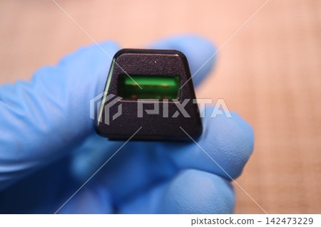 Gloved Hand Holding USB Port Component Gloved Hand Holding USB Port Component 142473229