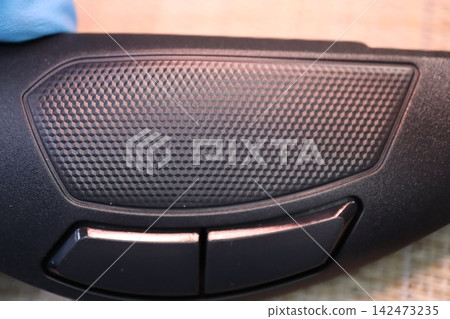 Car Interior Speaker Grille and Control Buttons Close-up Car Interior Speaker Grille and Control Buttons Close-up 142473235