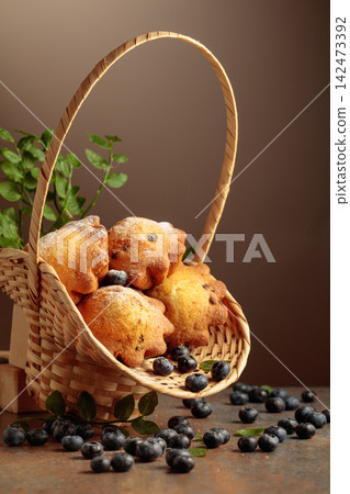 Freshly baked blueberry muffins in elegant basket. Freshly baked blueberry muffins in elegant basket. 142473392