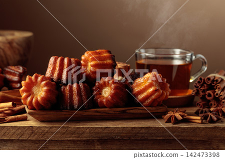 Cinnamon cakes and tea on an old wooden table. 142473398
