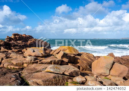 Waves crashing on granite cliffs in Tregastel, Brittany, France Waves crashing on granite cliffs in Tregastel, Brittany, France 142474032
