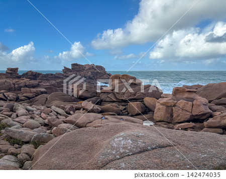 Waves crashing on granite cliffs in Tregastel, Brittany, France Waves crashing on granite cliffs in Tregastel, Brittany, France 142474035