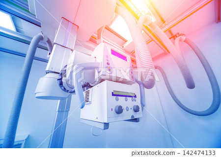 X-ray room in a hospital. Classic ceiling-mounted x-ray system. X-ray room in a hospital. Classic ceiling-mounted x-ray system. 142474133