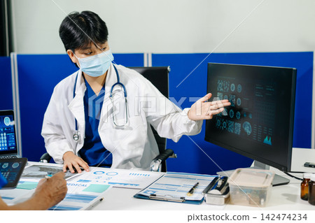 A dedicated medical team discusses patient diagnostics, reviewing brain MRIs and medical charts on digital devices A dedicated medical team discusses patient diagnostics, reviewing brain MRIs and medical charts on digital devices 142474234