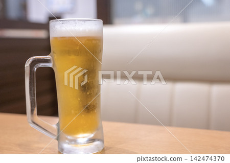 A glass of draft beer with a fine, creamy head. A glass of draft beer with a fine, creamy head. 142474370